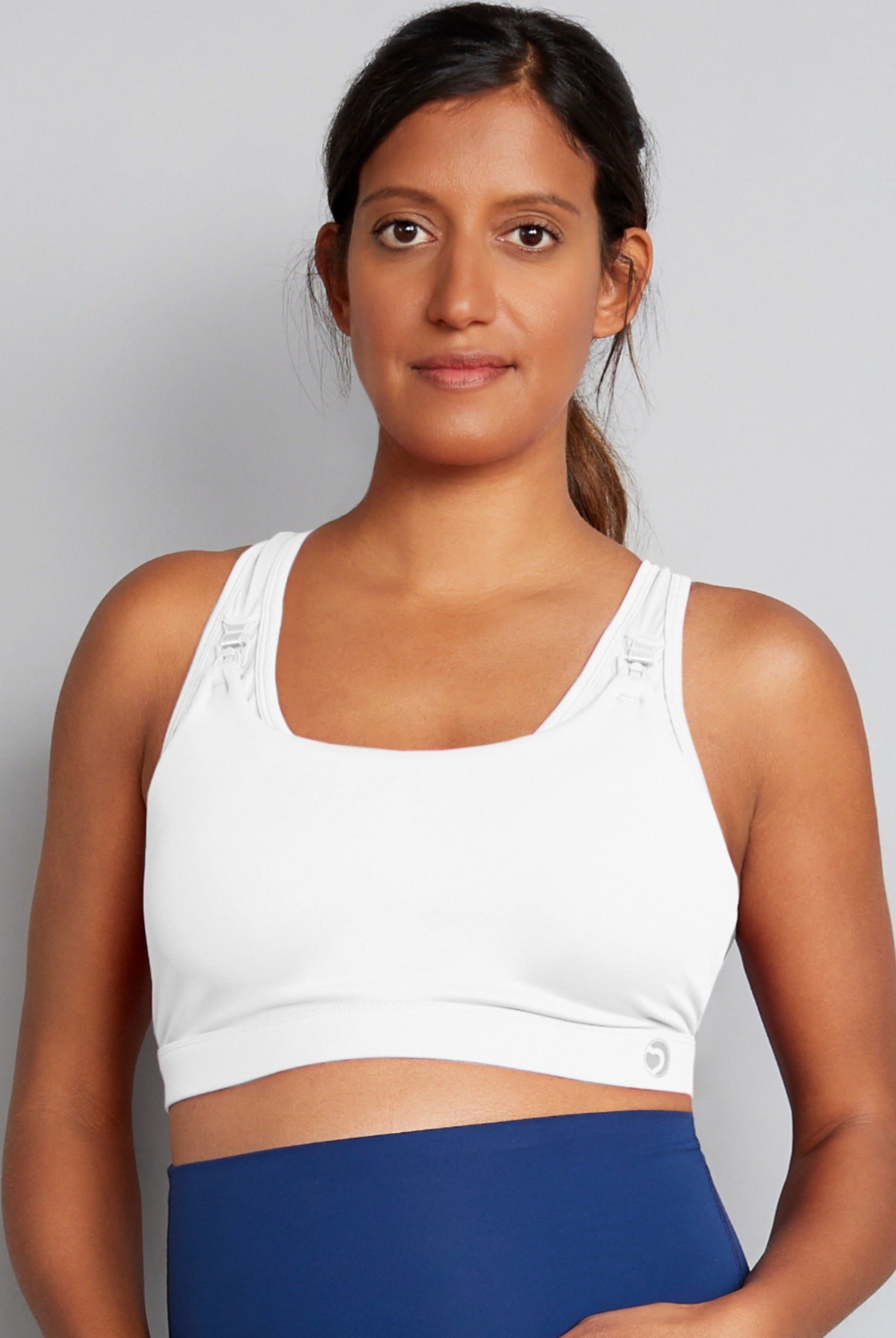 White nursing sports bra with blue leggings. Front view