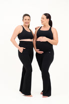 Mum wearing flared maternity leggings in black