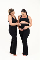 Mum wearing flared maternity leggings in black