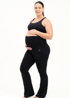 Mum wearing flared maternity leggings in black