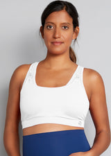 White nursing sports bra with blue leggings. Front view